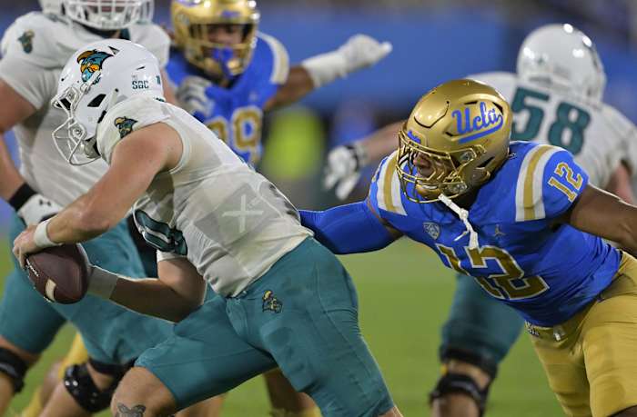 Sep 2, 2023; Pasadena, California, USA; UCLA Bruins defensive lineman Grayson Murphy (12) pressures Coastal Carolina Chanticleers quarterback Grayson McCall (10) in the first half at Rose Bowl. Mandatory Credit: Jayne Kamin-Oncea-USA TODAY Sports  